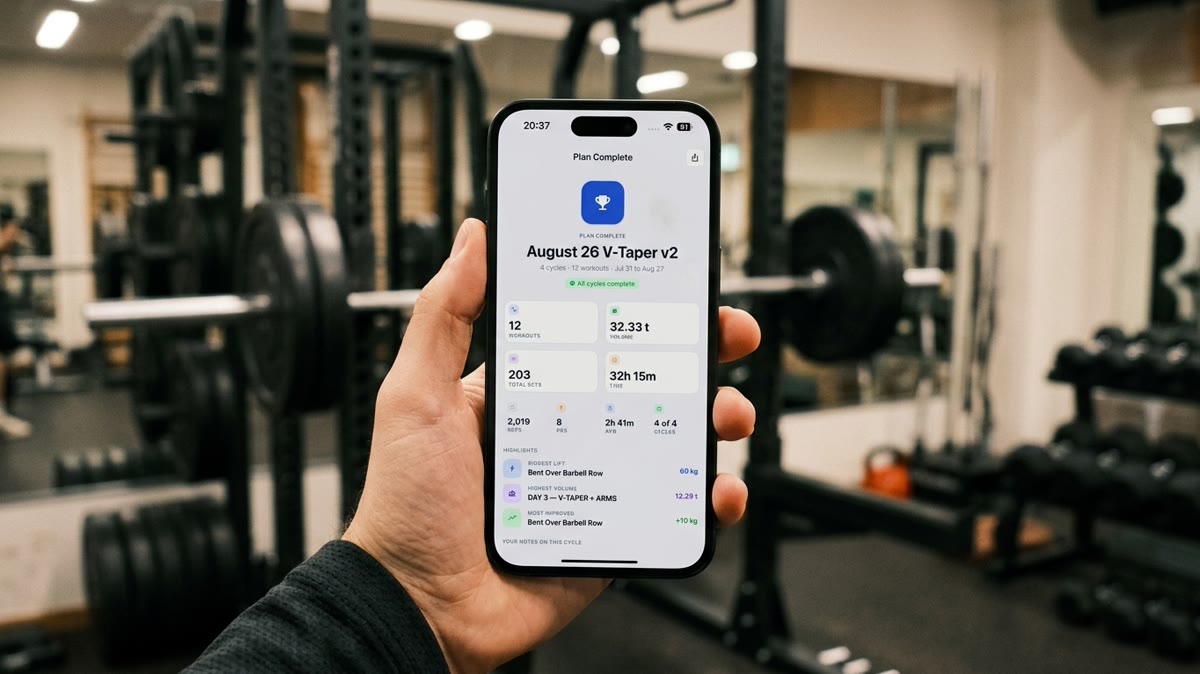 A hand holding a phone in a gym showing Repport's finished-plan summary, ready to export